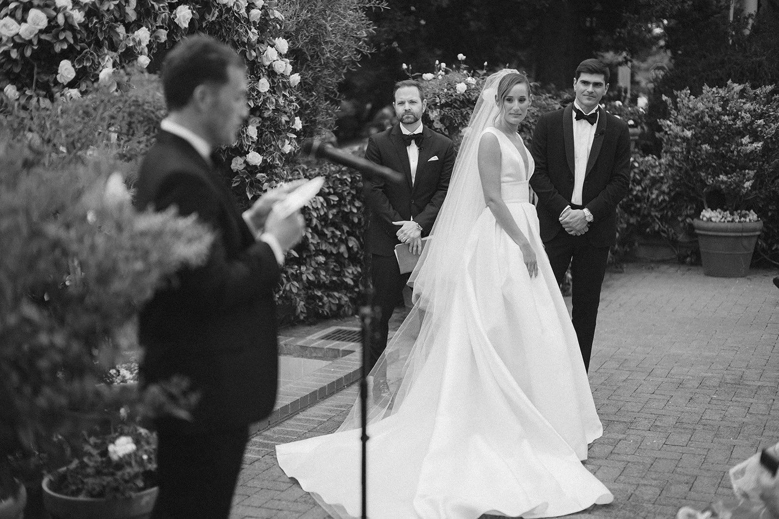bride and groom listening to a reading