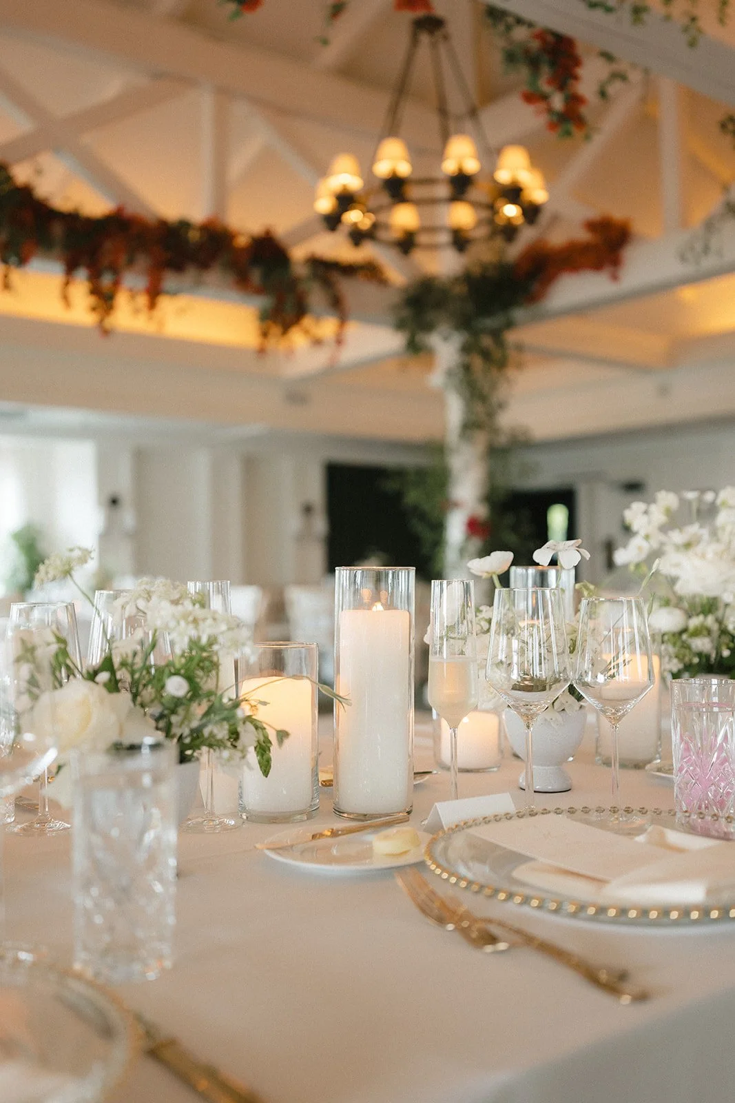 wedding head table with flower arrangements and candles