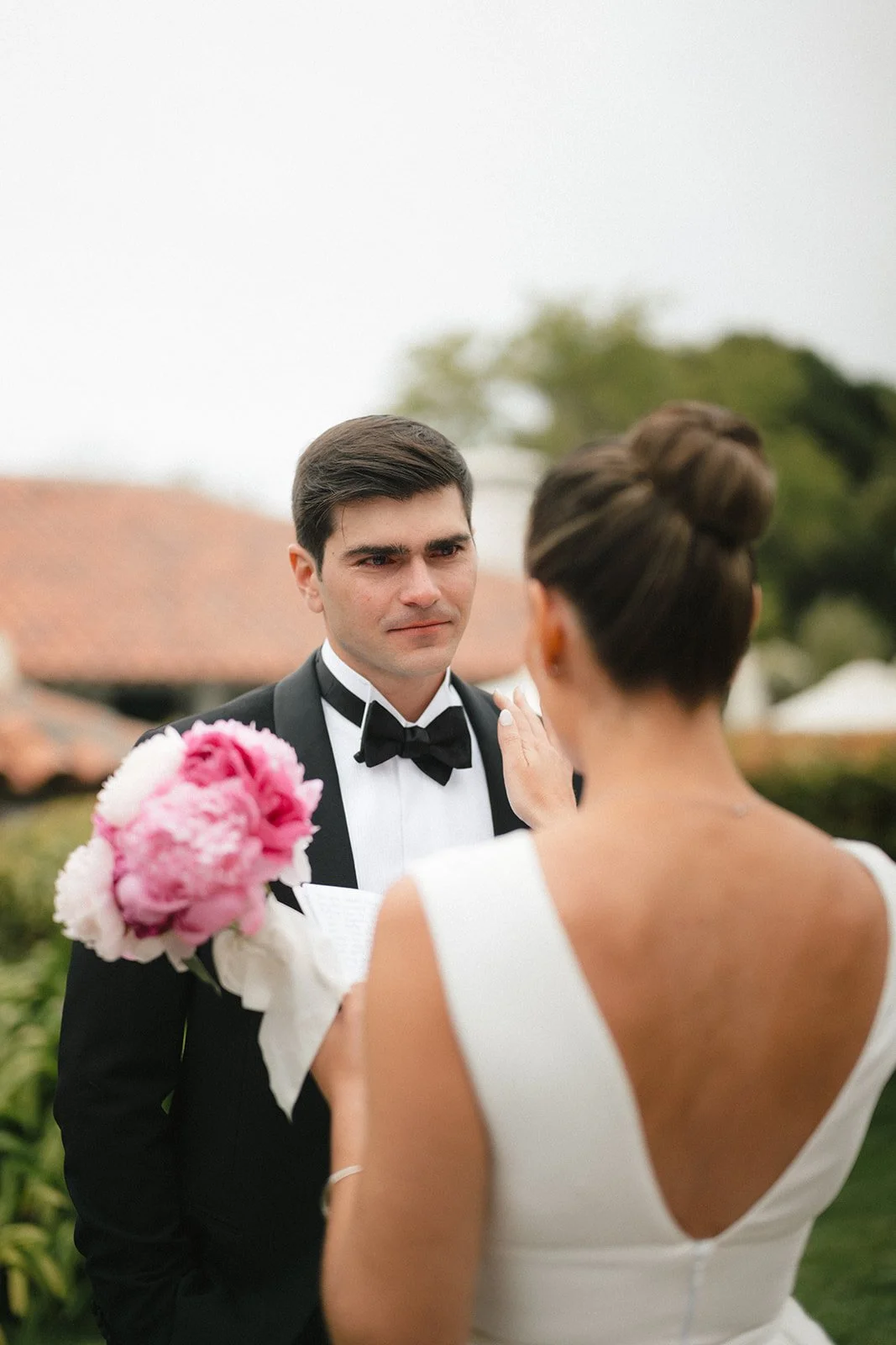 groom and bride with peony bouquet