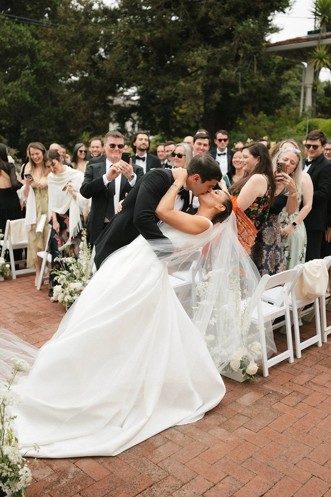 couple kissing in the wedding aisle