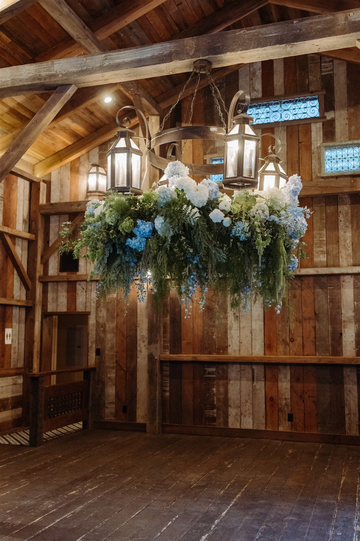 hanging floral chandelier inside a rustic lodge