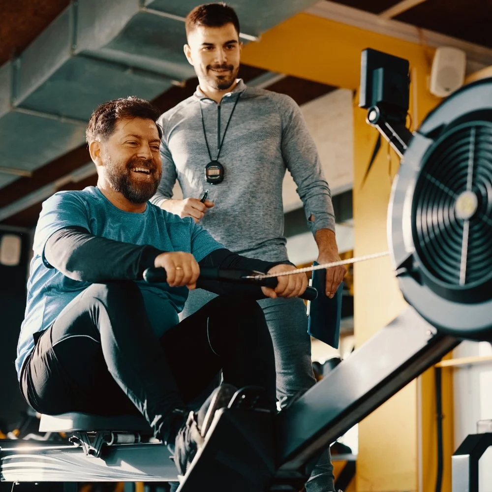Man Learning To Row with a Coach