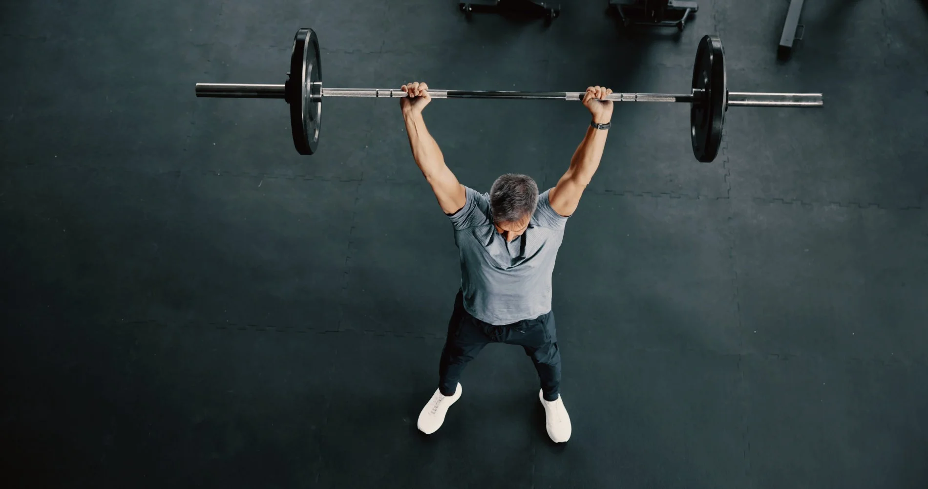 man over 40 strength training with a barbell