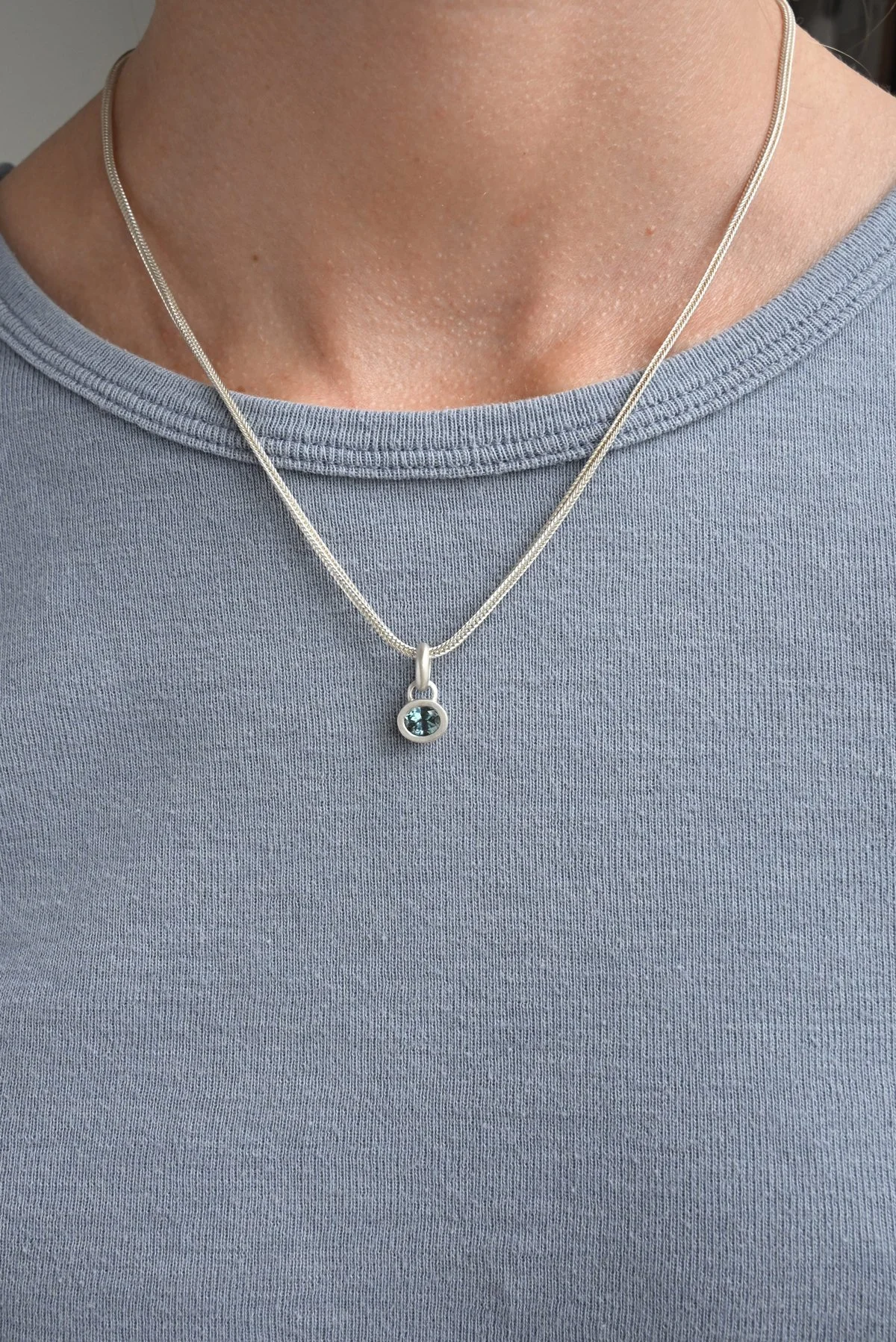 Dunton-Ellerkamp-Silver-Sapphire-Pendant-On-Figure-Teal.jpg