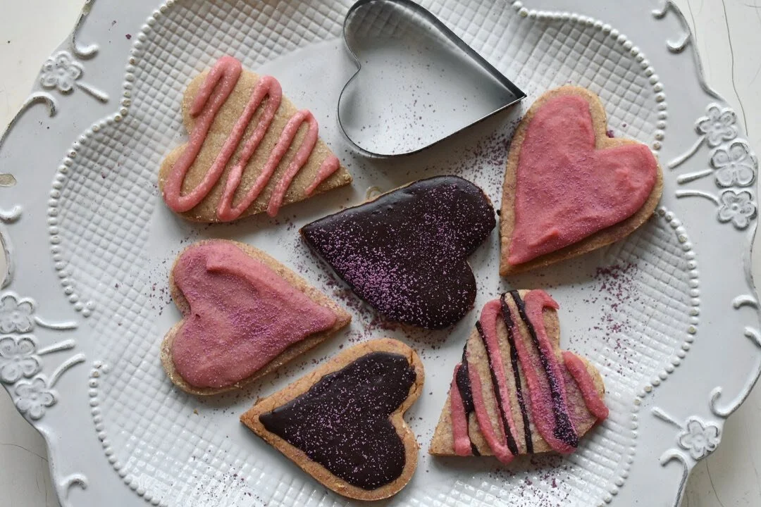 Strawberry Rose Cut Out Cookies with Dark Chocolate and Rose Icing~
I’ve made them without grains, dairy or refined sugar. Monk fruit sweetener is an excellent alternative to cane sugar. 
Rose is a gentle heart warming medicine that brings in