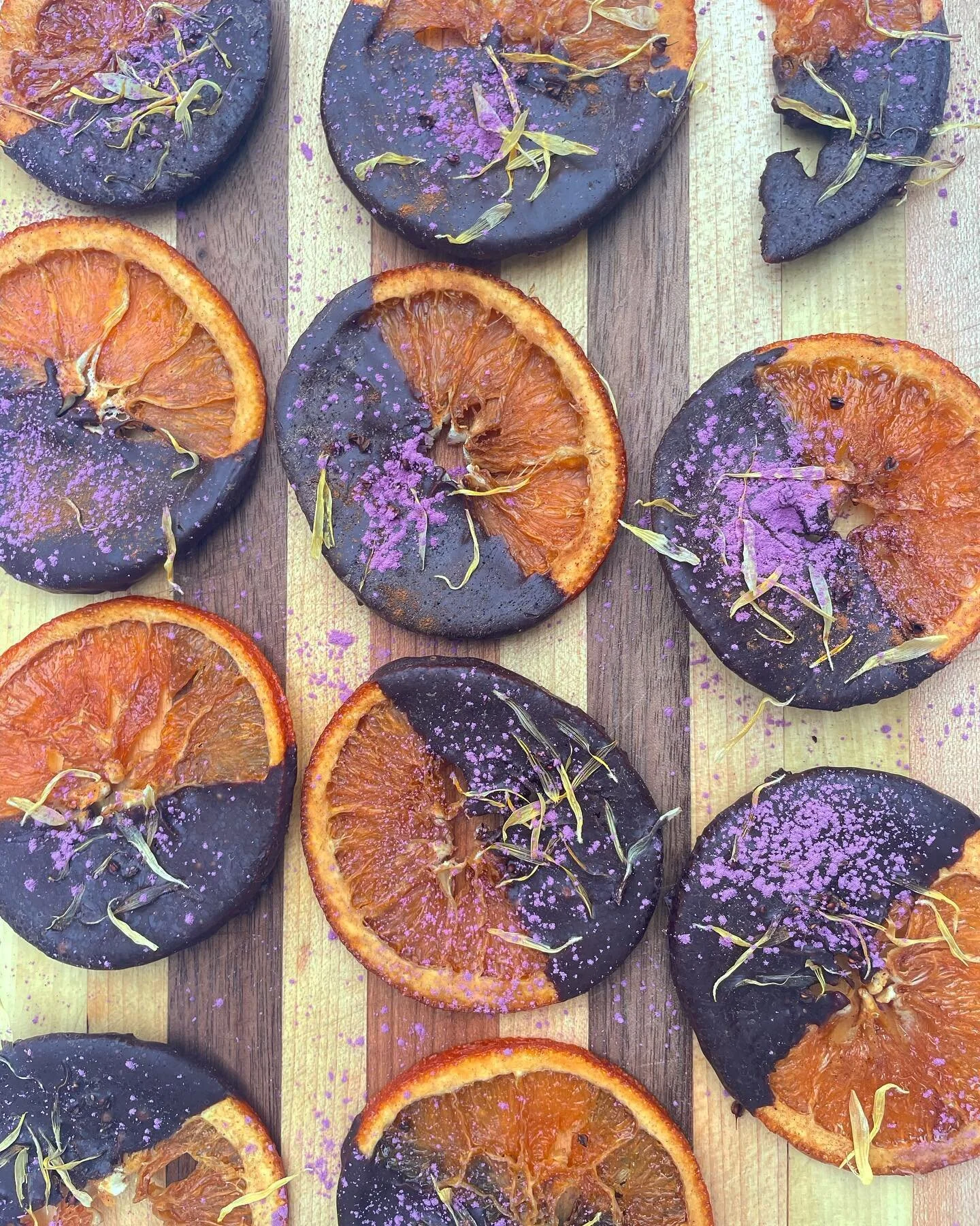 Happy holidays to all those celebrating! Enjoy these sumptuous, juicy oranges dipped in dark chocolate mmm mmm mmm.
Topped with calendula flowers, rose powder and yellow dock seeds. 
Soak the rind in maple syrup with a little cinnamon if you want t