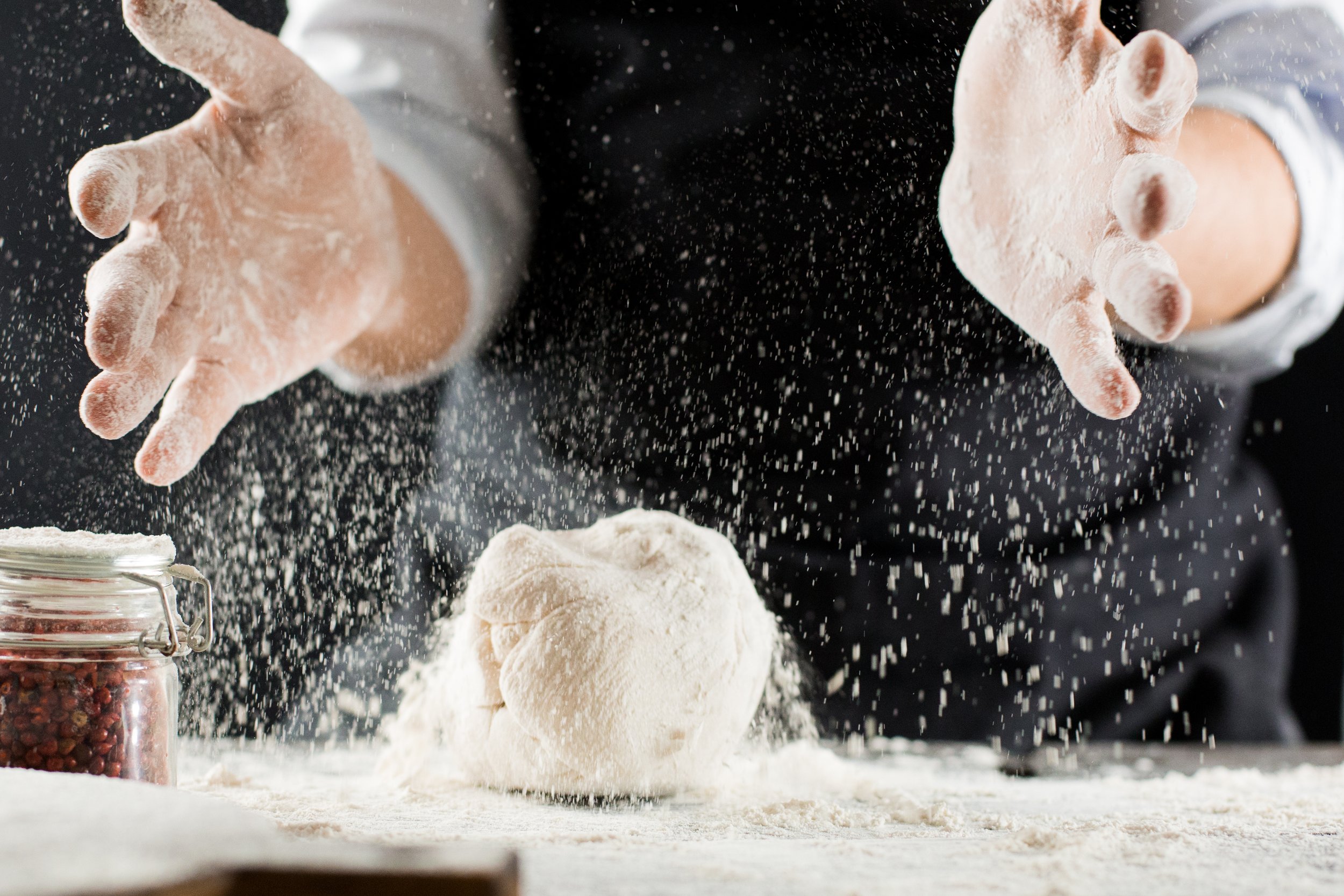 cook-kneads-dough-with-flour-on-kitchen-table-2021-10-21-02-26-06-utc.JPG