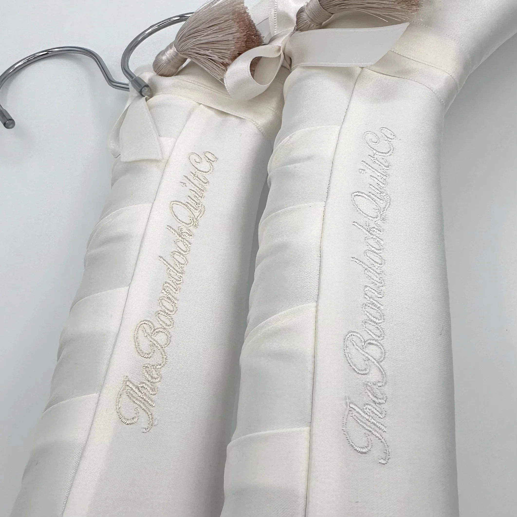 Ivory Satin Ivory Thread v  White Thread on ivory satin bridal hanger by the boondock quilt co.  Custom satin wedding dress hanger.