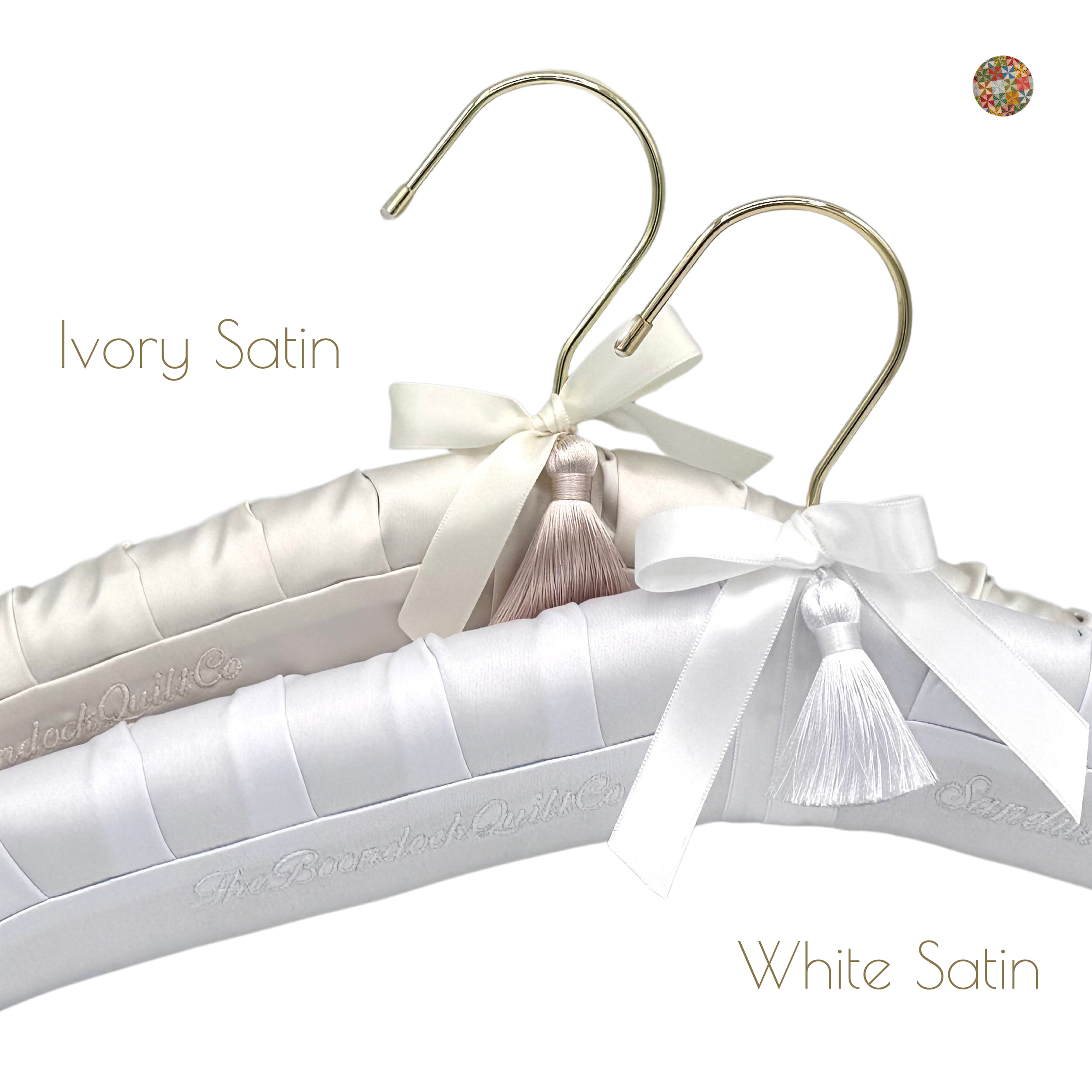 Three satin padded hangers with bows, one ivory satin, one white satin, and one light pink tassel, labeled 'Ivory Satin' and 'White Satin'.