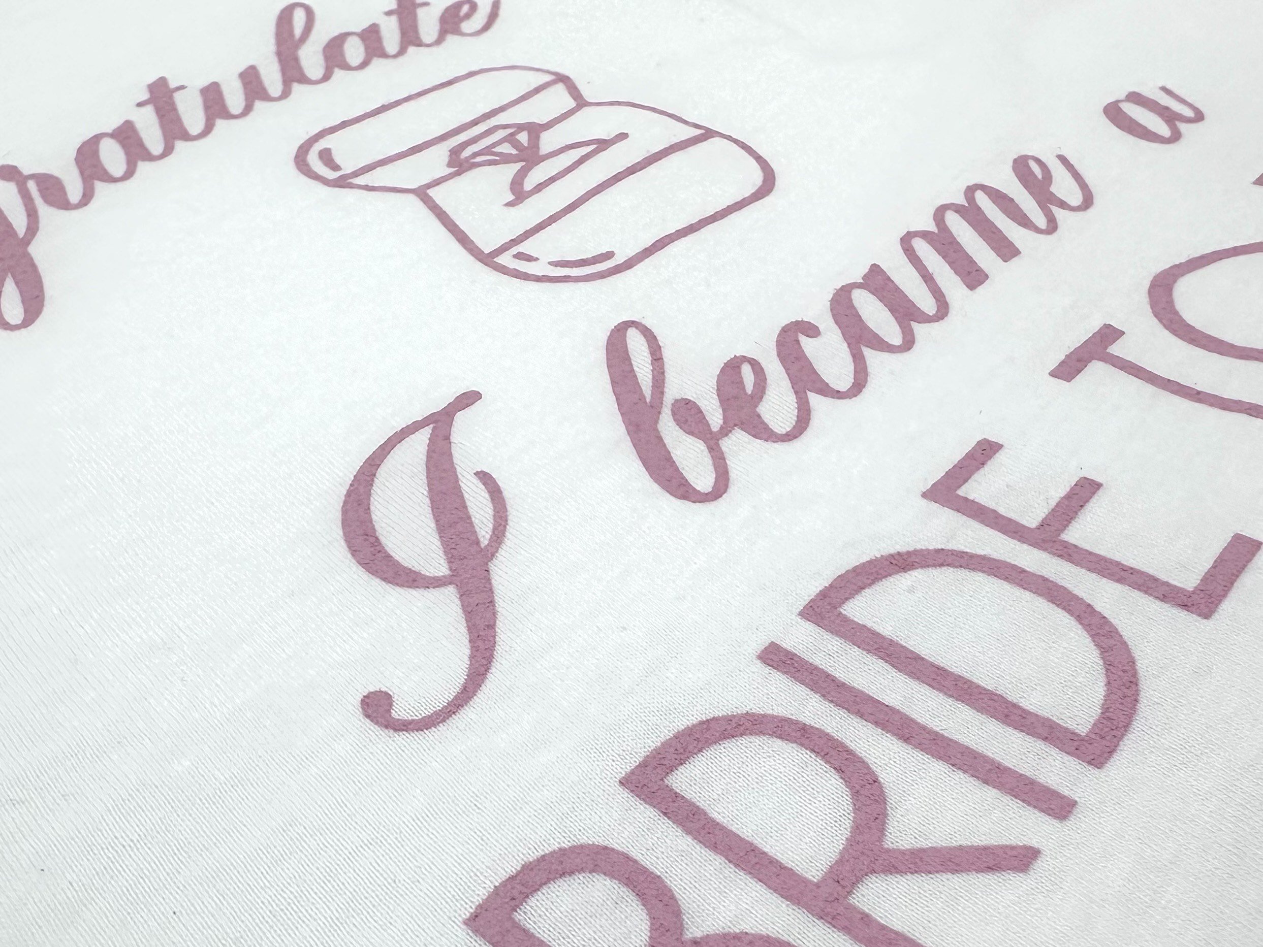Screen printed "Congratulate me I became a bride to be" White cotton T-shirt with Rose Pink lettering"