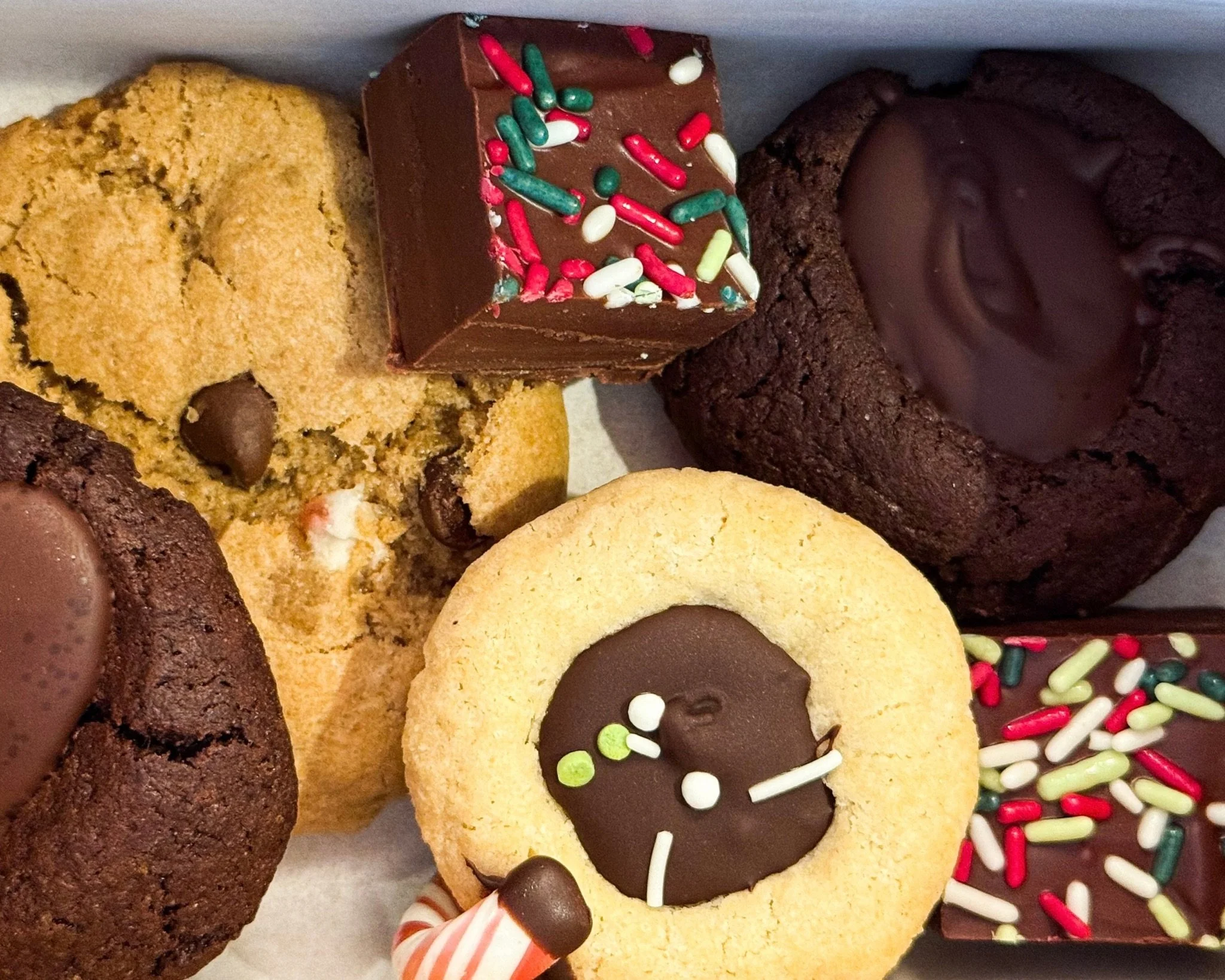 Assorted allergy-friendly holiday cookies arranged in a box