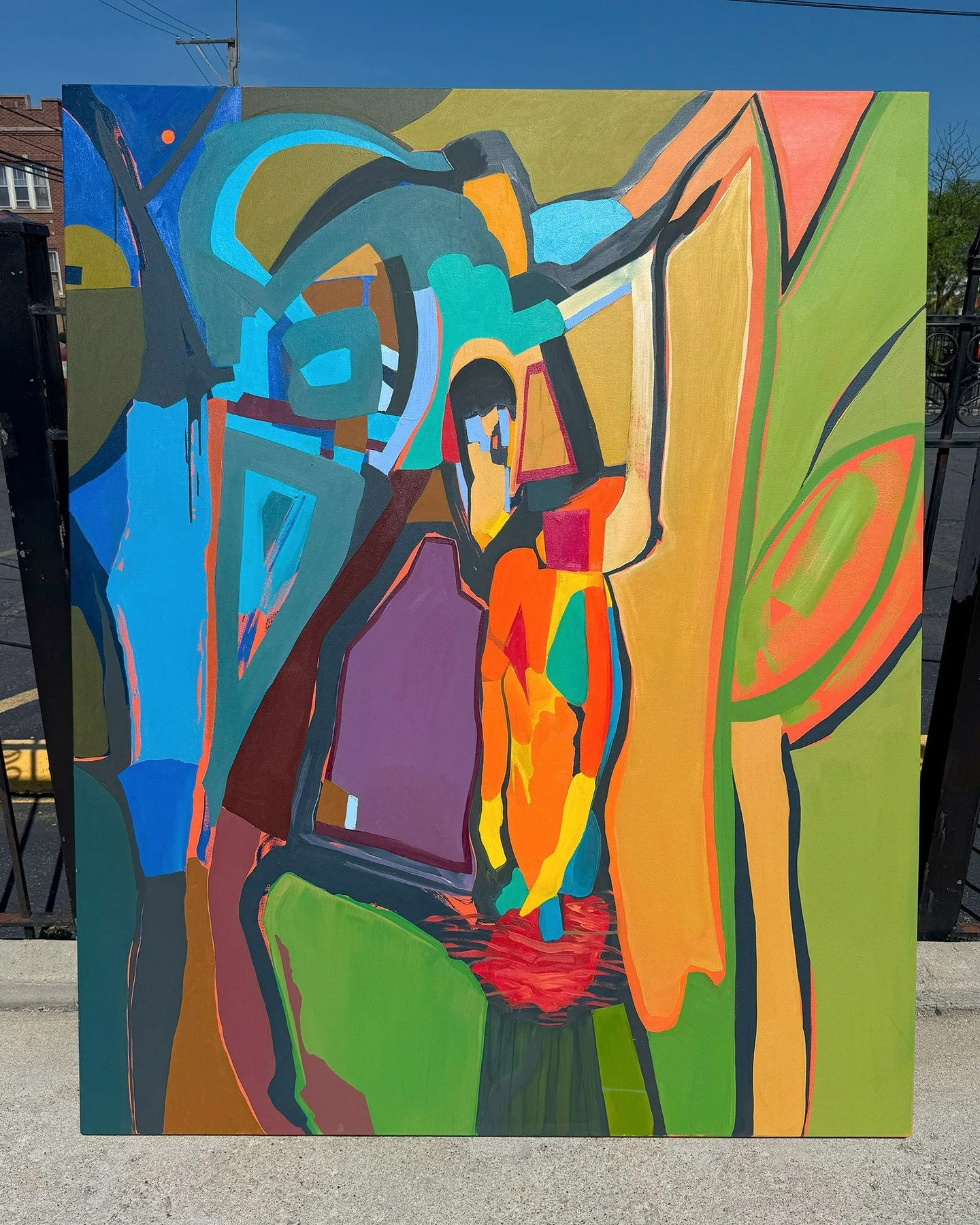 Large-scale, colorful, abstract painting photographed outdoors for maximum impact. A seated figure is positioned in the center of this piece. I'm considering painting it out. It's the only part of the painting I'm least sure about. I'm also feeling s