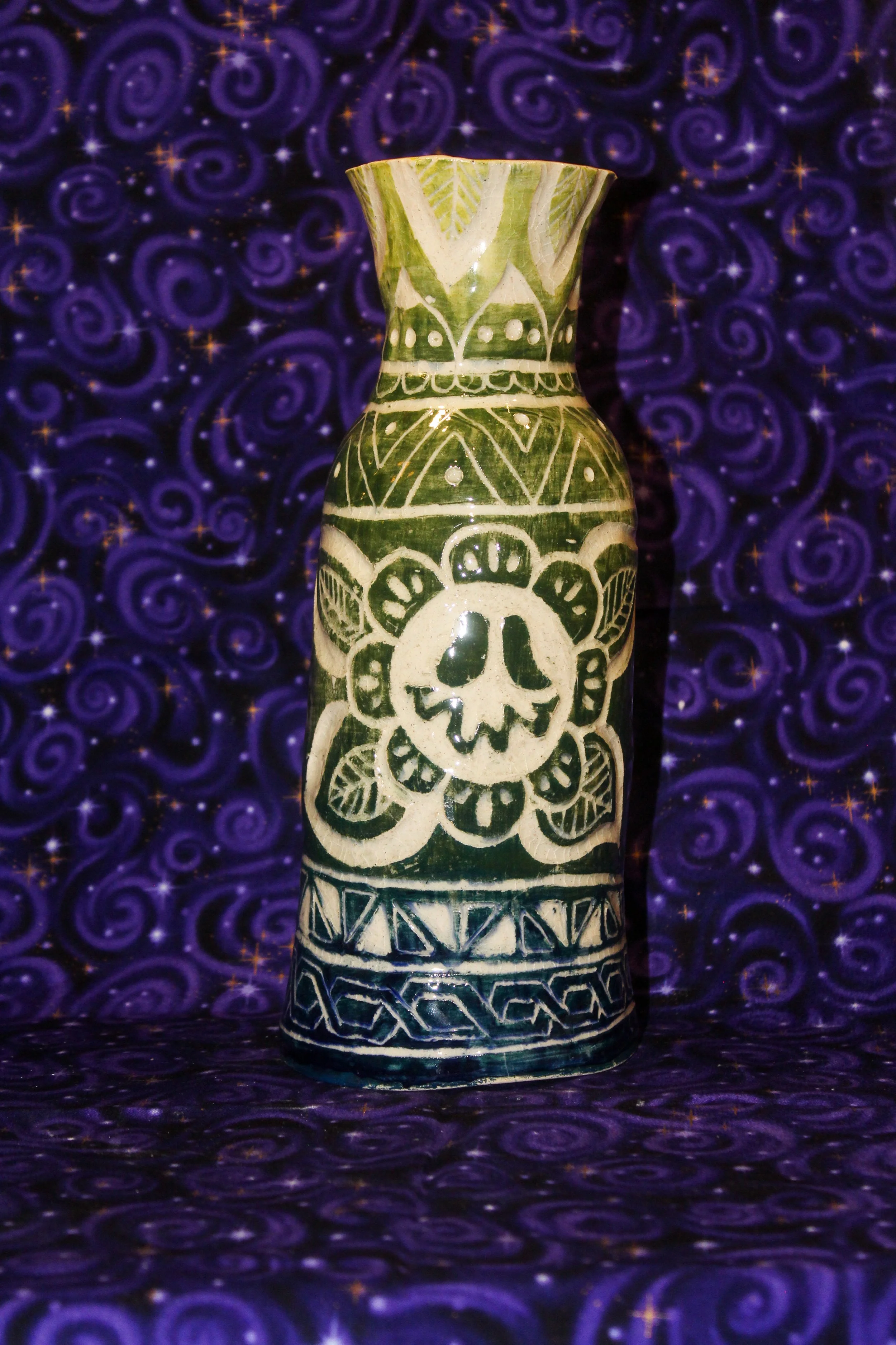 Vase with blue to yellow gradient, and carved flower. 