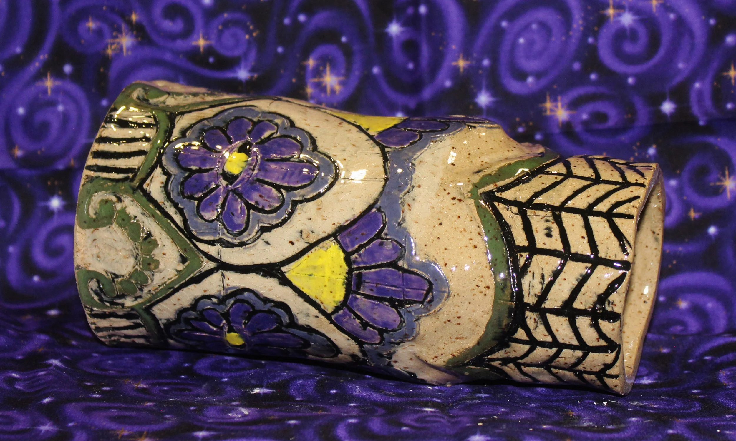Speckled vase with purple flowers
