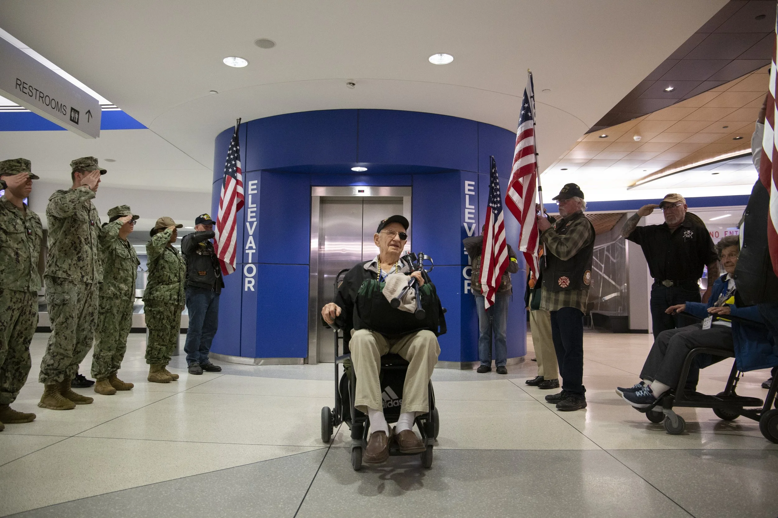 Edward Barrett, a World War II veteran, arrives home to a warm welcome at the Frederick Douglass Greater Rochester International Airport in Rochester N.Y. on Feb. 22, 2024. Barrett was given the chance to visit the National WWII Museum in New Orleans
