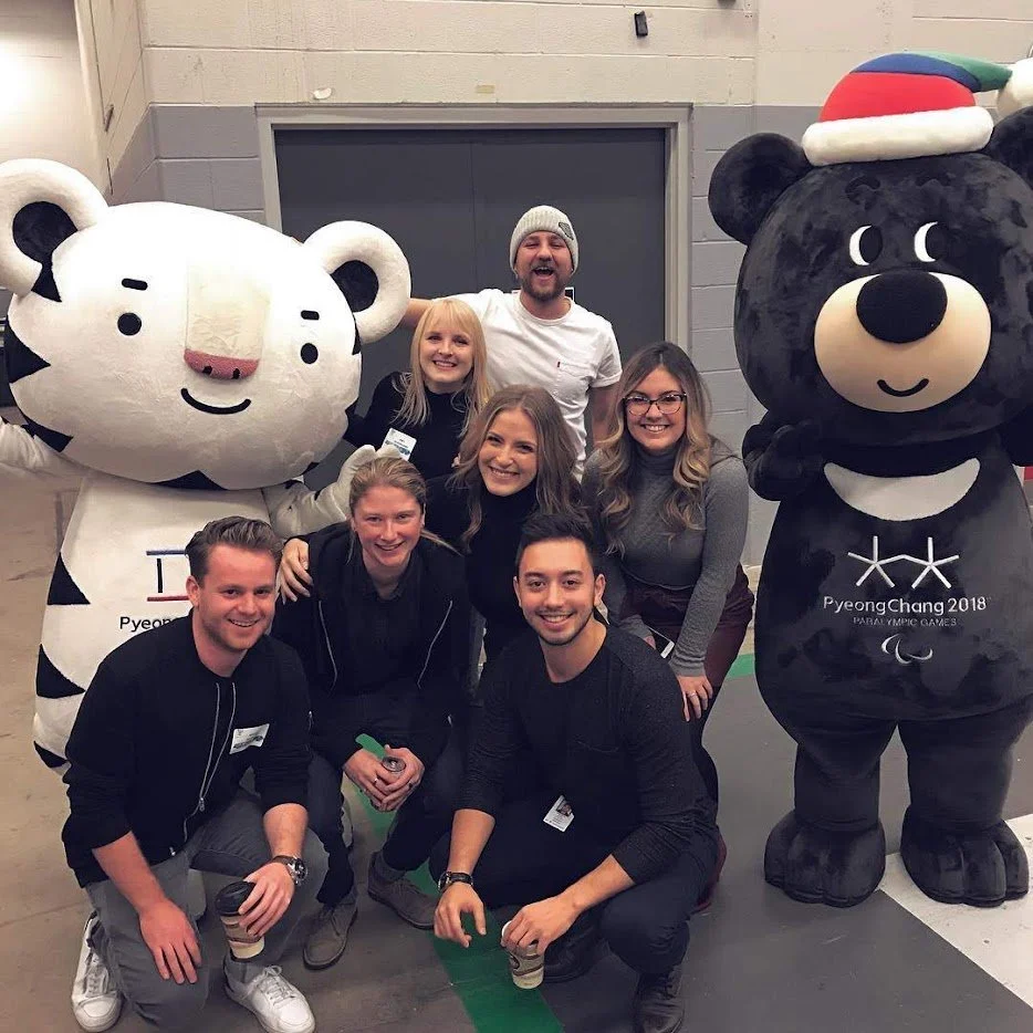 Group of people posing with large tiger and bear mascot costumes at the PyeongChang 2018 Winter Paralympic Games