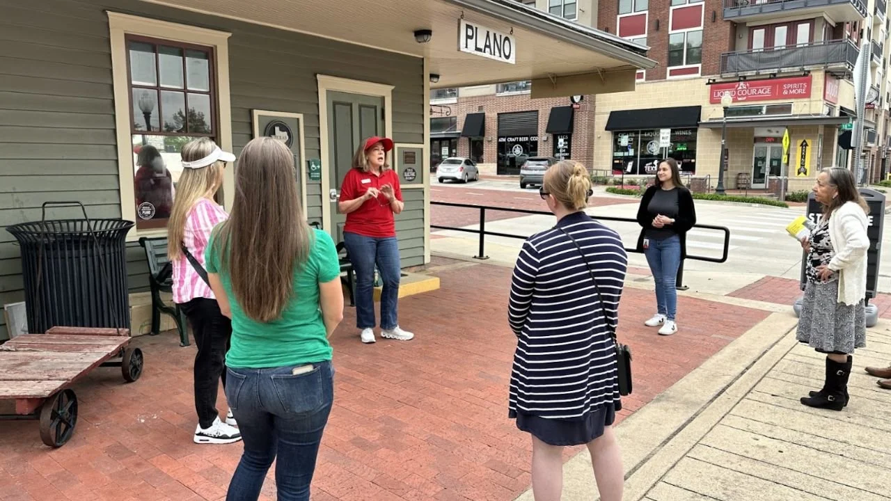 Guided walking tour group gathered outside historic building in Downtown