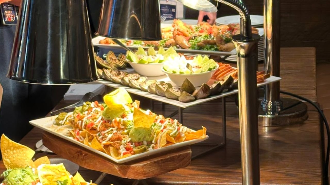Buffet table with loaded nachos, appetizers, and serving lamps at restaurant on Lone Star Food Tours’ food tour