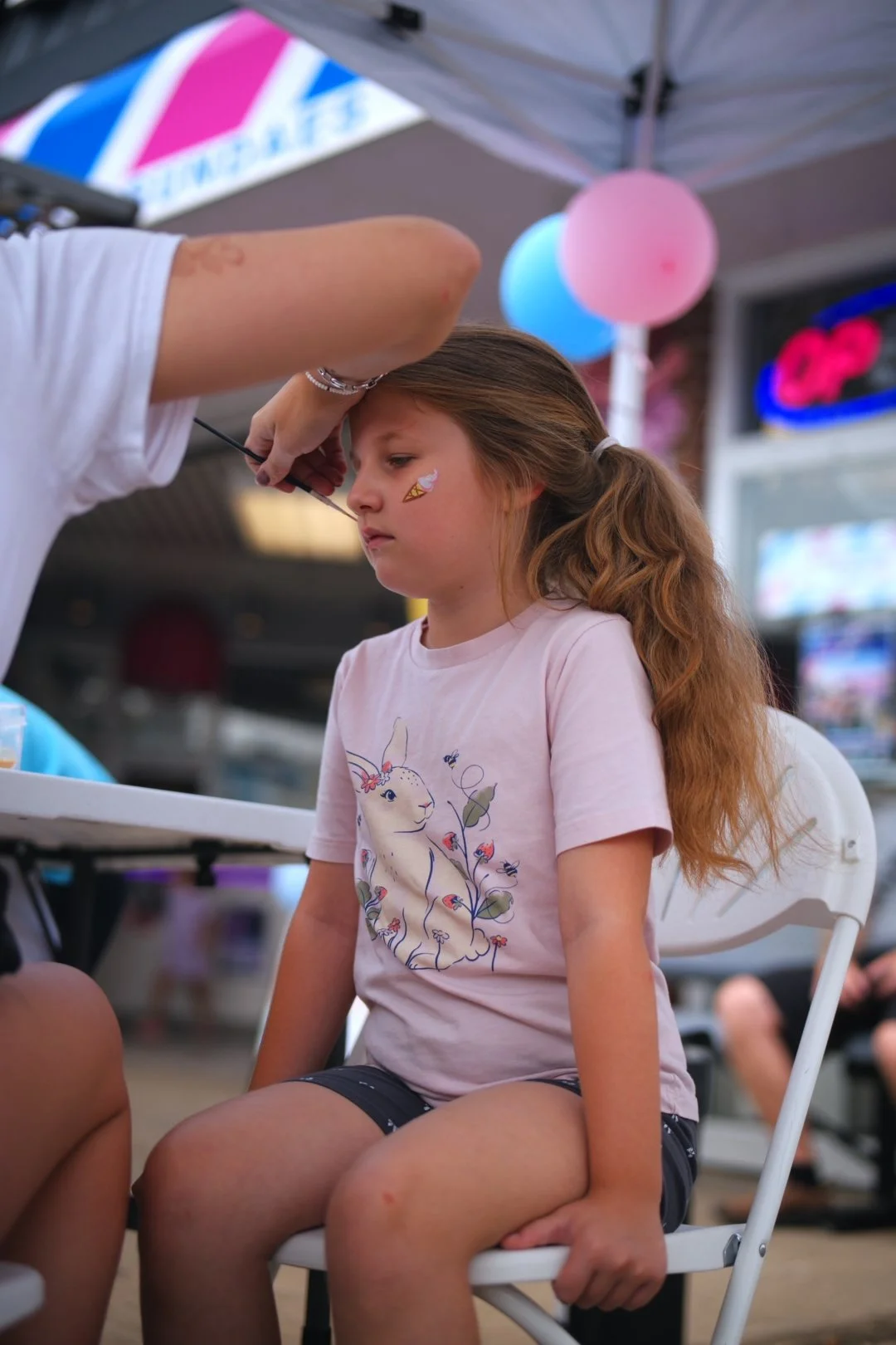 A child at the face-painting booth during National Ice Cream Day 2026 at Merla-Mae in London, Ontario