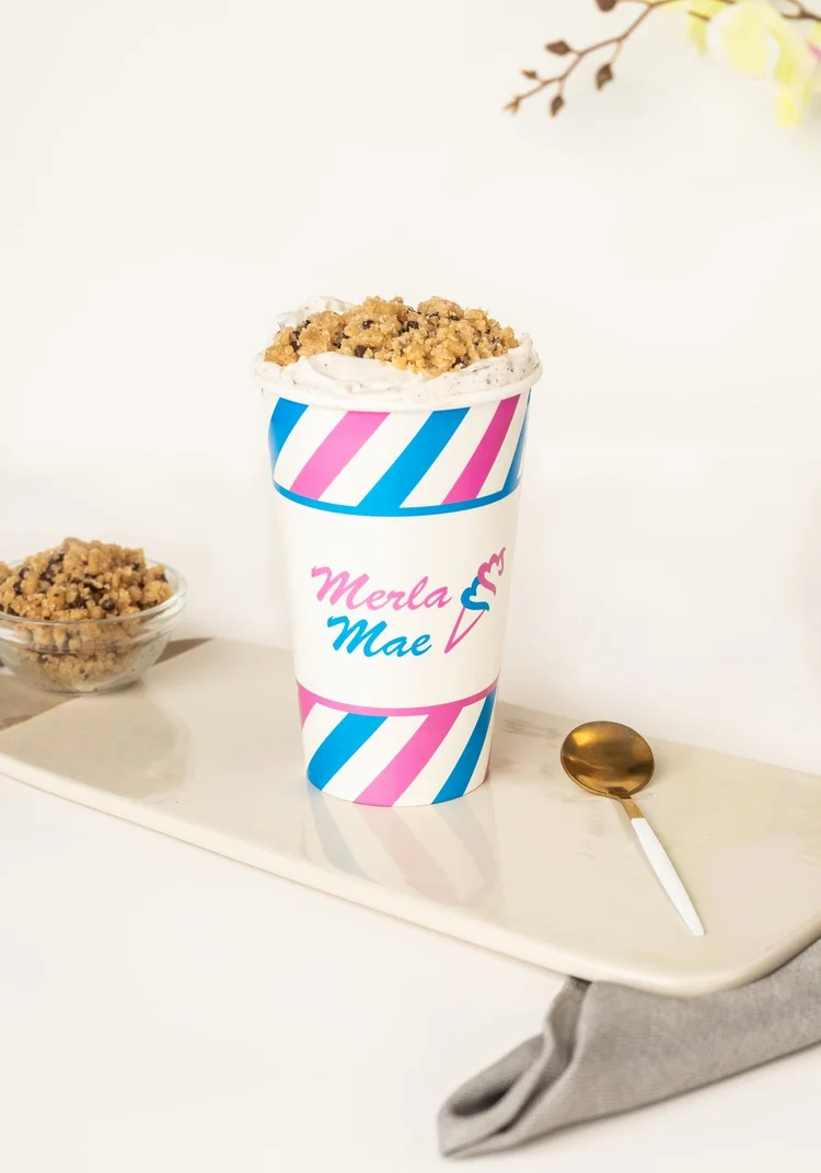 Cookie Dough Cream Shake Flurry topped with cookie dough pieces in a striped cup at Merla-Mae Ice Cream in London, Ontario
