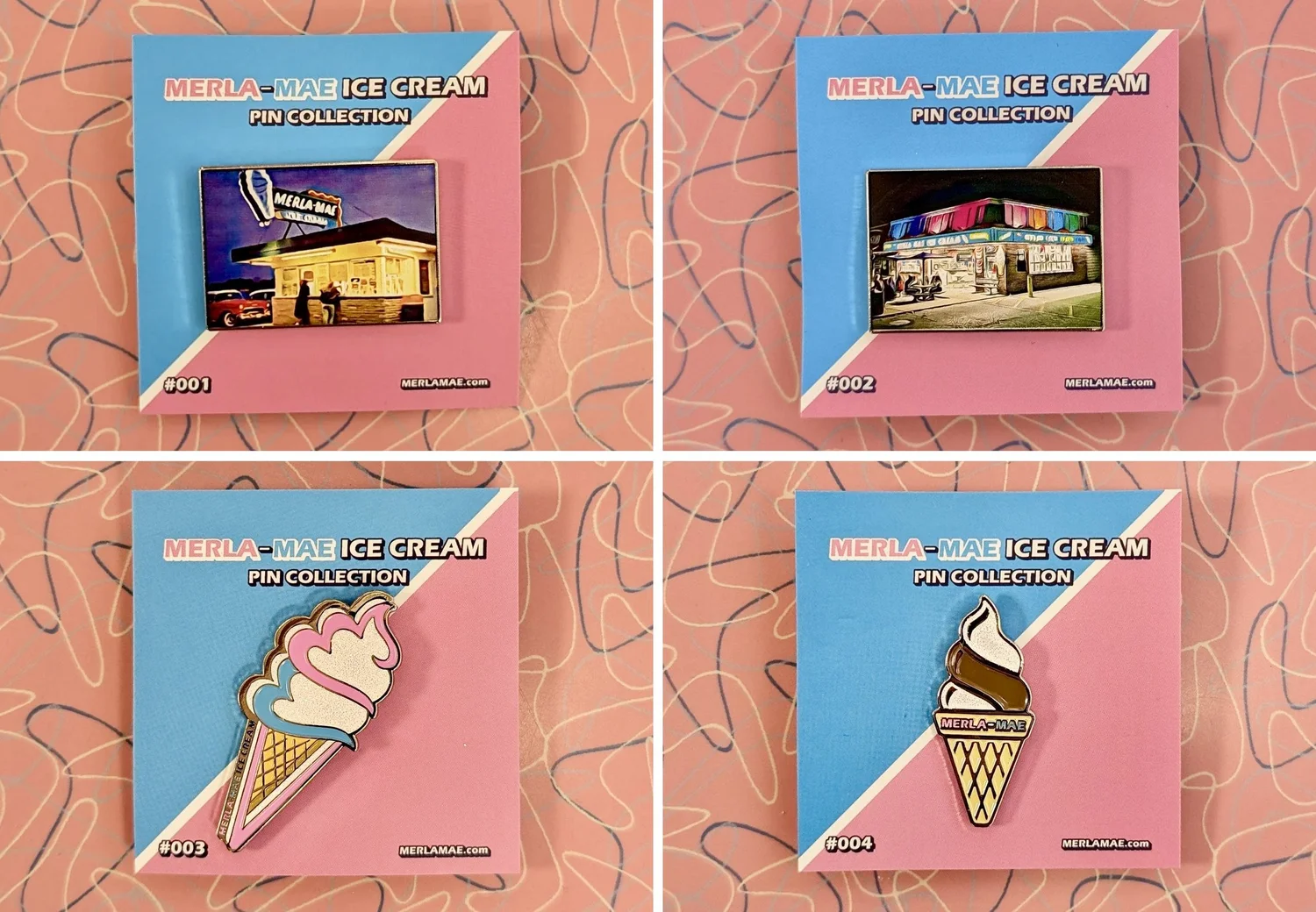 The four Merla-Mae enamel pins on their numbered Pin Collection cards: #001 the original shack, #002 the ice cream store, #003 the logo cone and #004 a twist cone, on the pink boomerang table at Merla-Mae Ice Cream in London, Ontario