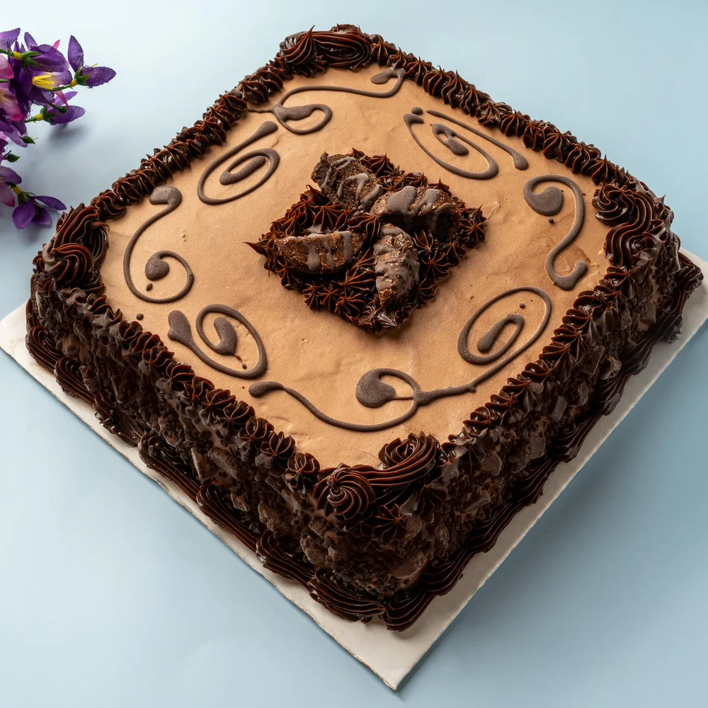 Square chocolate ice cream cake with piped chocolate icing and chocolate pieces at Merla-Mae Ice Cream in London, Ontario
