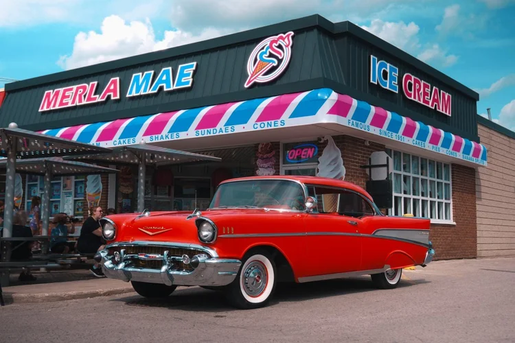 Red 1957 Chevrolet Bel Air parked outside Merla-Mae Ice Cream at the Chrome & Cones Car Show