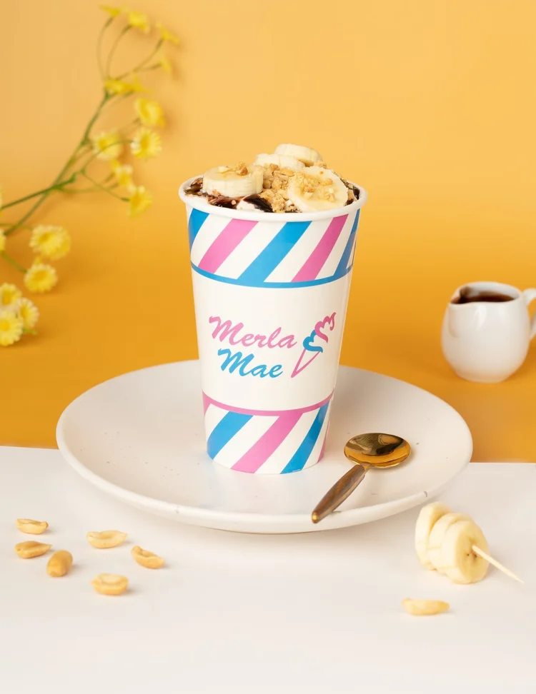 Monkey Shines Cream Shake Flurry topped with banana slices in a striped cup at Merla-Mae Ice Cream in London, Ontario
