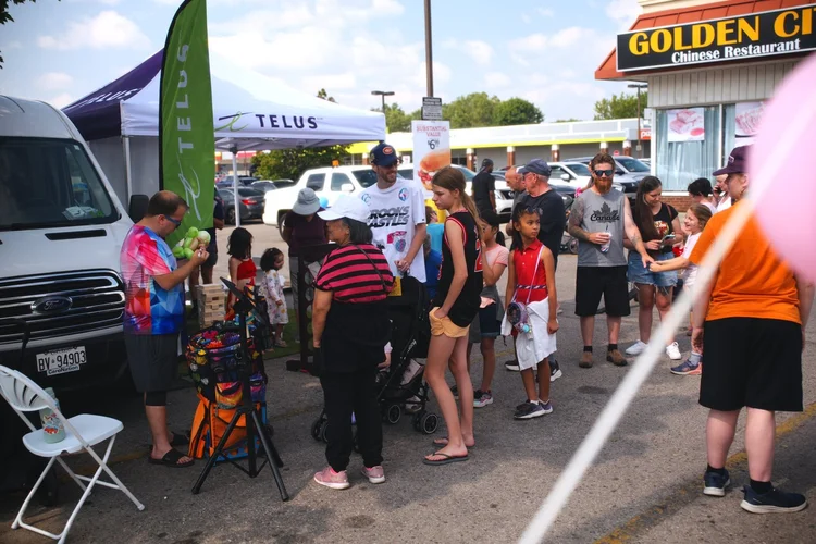Families at the TELUS games tent during National Ice Cream Day 2026 at Merla-Mae Ice Cream in London, Ontario