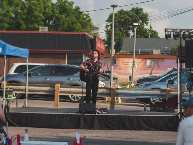 Tyrone Traher performing on the parking-lot stage at National Ice Cream Day 2024, Merla-Mae Ice Cream in London, Ontario