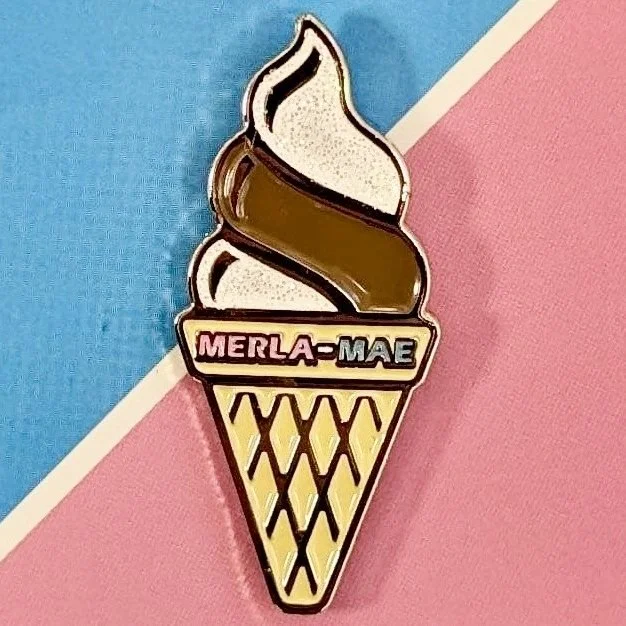 Pin #004 Ice Cream Cone enamel pin of a half and half twist soft-serve cone, on its Pin Collection card