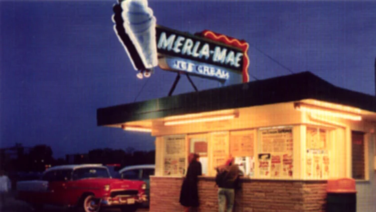 Vintage night photo of the Merla-Mae Ice Cream stand in London, Ontario, lit up under its neon cone sign
