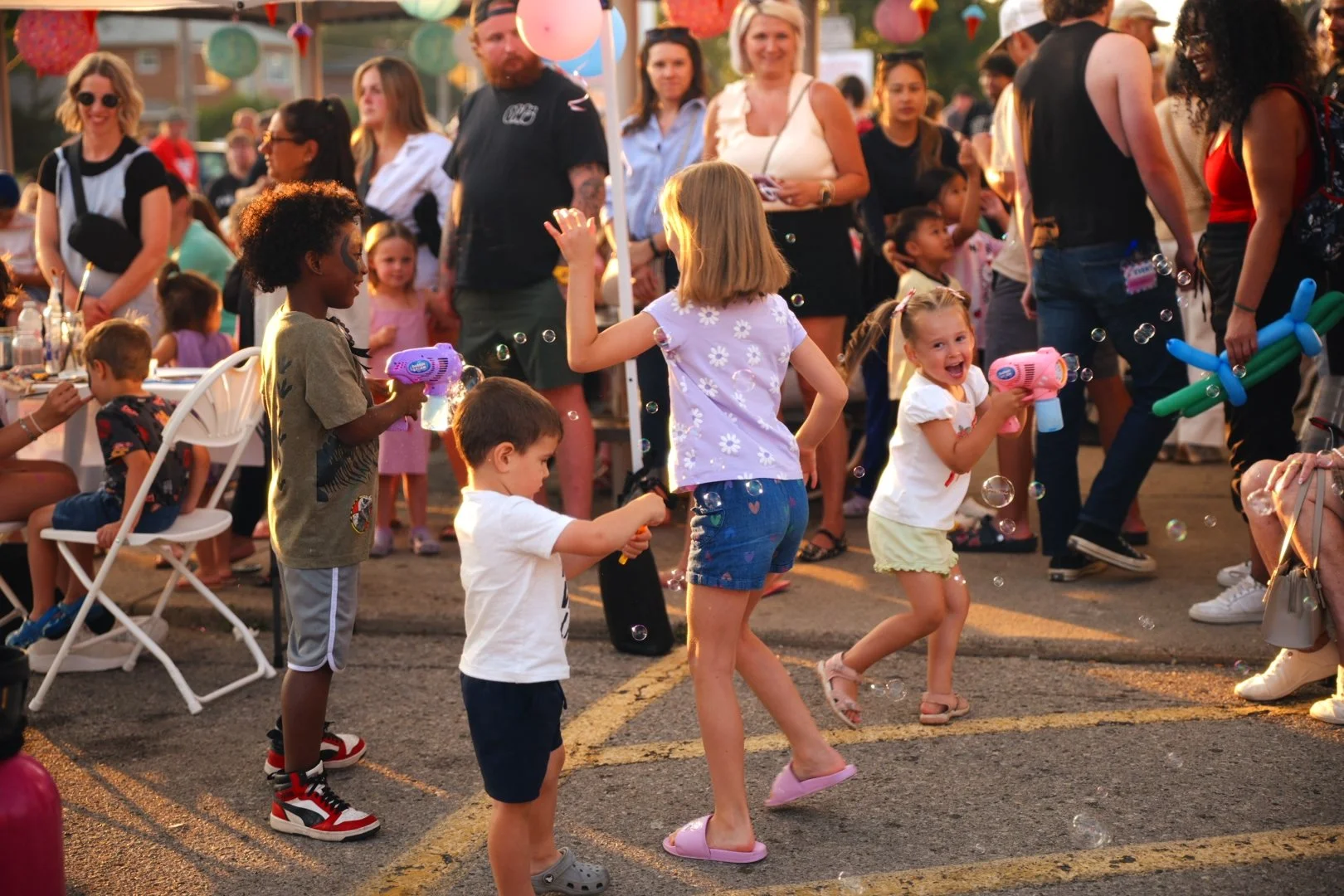 Children playing and blowing bubbles at Merla-Mae's National Ice Cream Day 2026