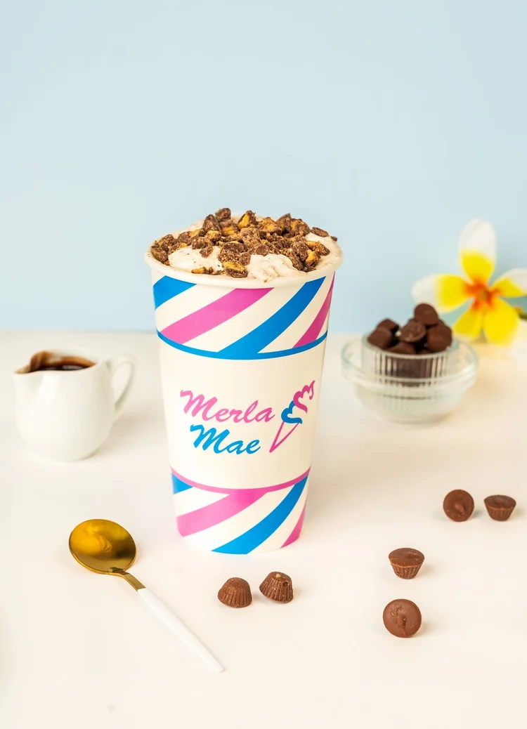 Moose Tracks Cream Shake Flurry with peanut butter cups in a striped cup at Merla-Mae Ice Cream in London, Ontario