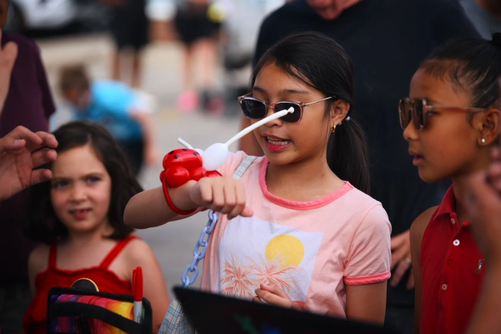 A young guest with a balloon animal at Merla-Mae's National Ice Cream Day 2026 in London, Ontario