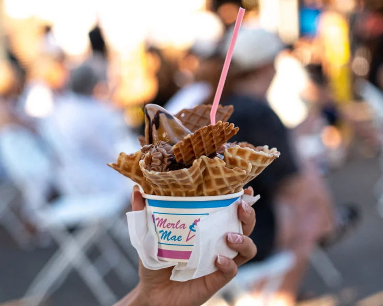 The Rottweiler Sundae in a waffle bowl and striped Merla-Mae cup, held over the crowd at National Ice Cream Day in London, Ontario
