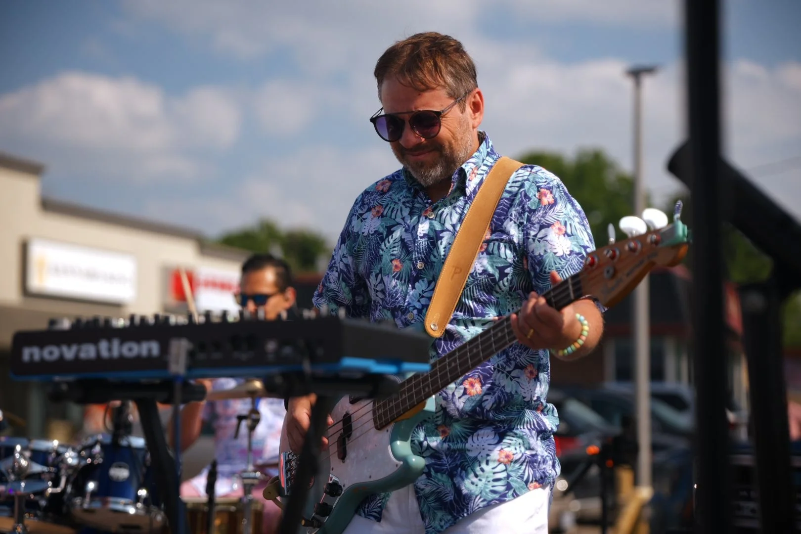 Sweet Theory's bassist on stage at National Ice Cream Day 2026, Merla-Mae in London, Ontario
