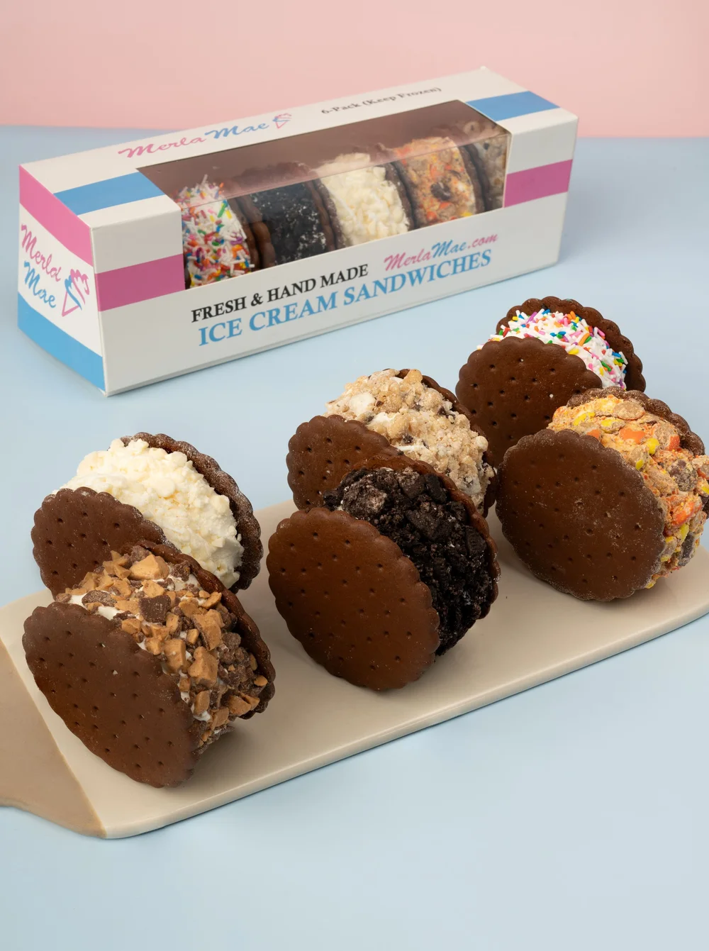 Hand-made ice cream sandwiches rolled in candy, cookie and sprinkle toppings in front of their box at Merla-Mae Ice Cream in London, Ontario