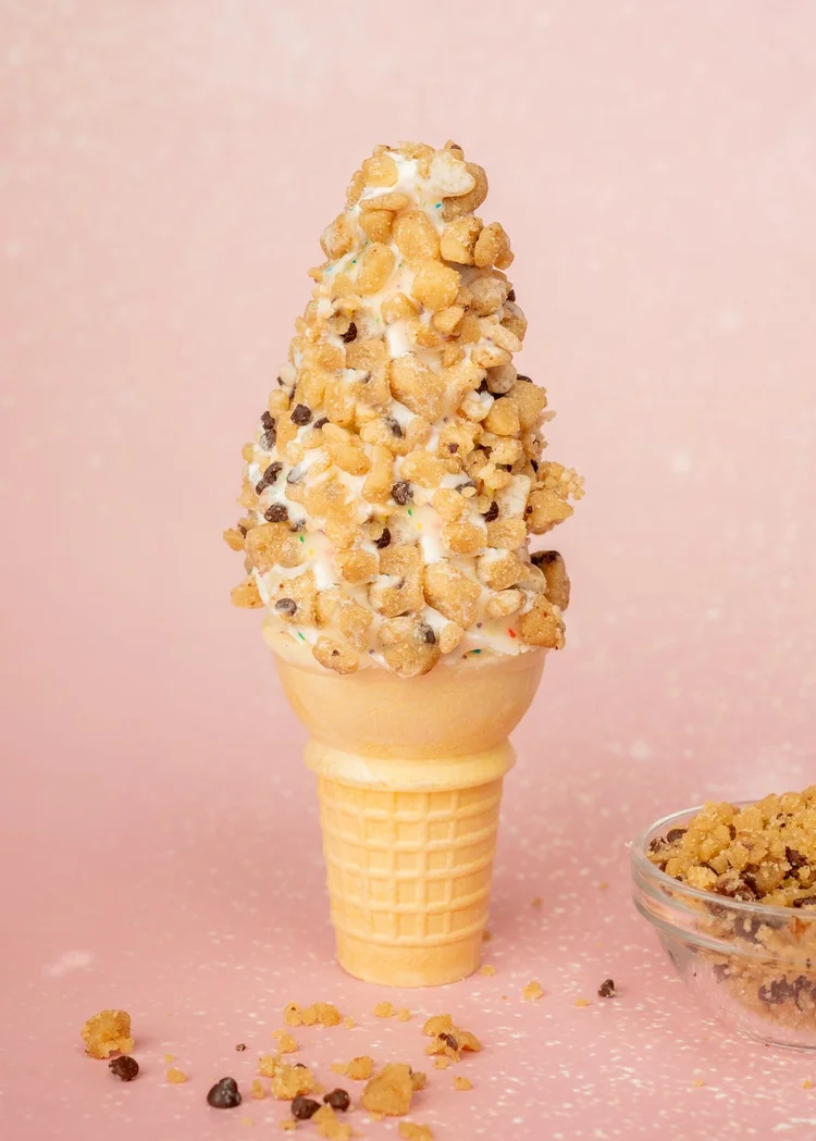 Vanilla soft-serve cone in Birthday Cake dip rolled in cookie dough at Merla-Mae Ice Cream in London, Ontario