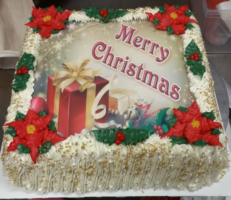 Merry Christmas ice cream cake with red icing poinsettias, holly and gold sugar, at Merla-Mae Ice Cream in London, Ontario