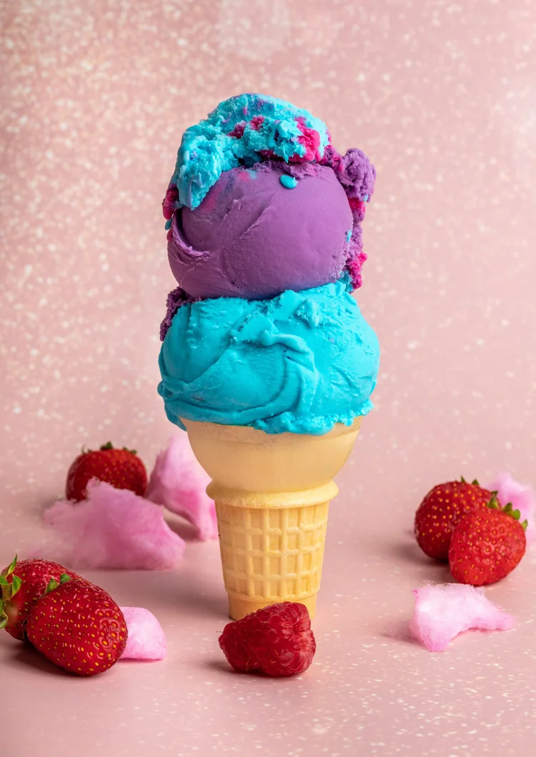 Two scoops of hard-scoop ice cream on a cake cone at Merla-Mae Ice Cream in London, Ontario