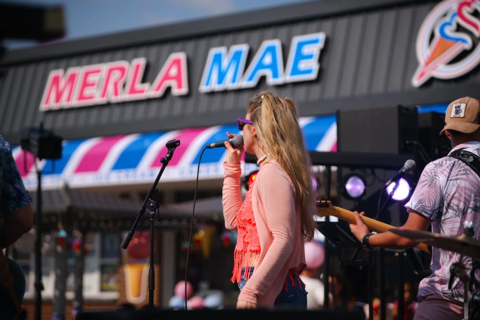 Sweet Theory's vocalist singing to the crowd at Merla-Mae's National Ice Cream Day 2026