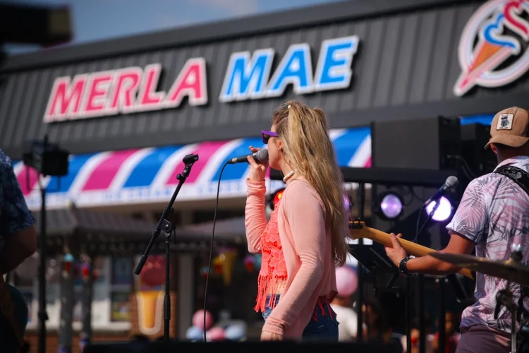 Sweet Theory's vocalist singing to the crowd at Merla-Mae's National Ice Cream Day 2026