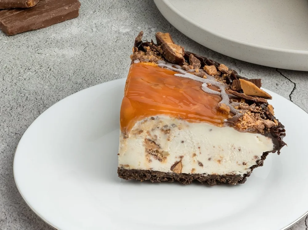 Slice of Skor ice cream pie with caramel topping, Skor pieces and a chocolate crumb base at Merla-Mae Ice Cream in London, Ontario