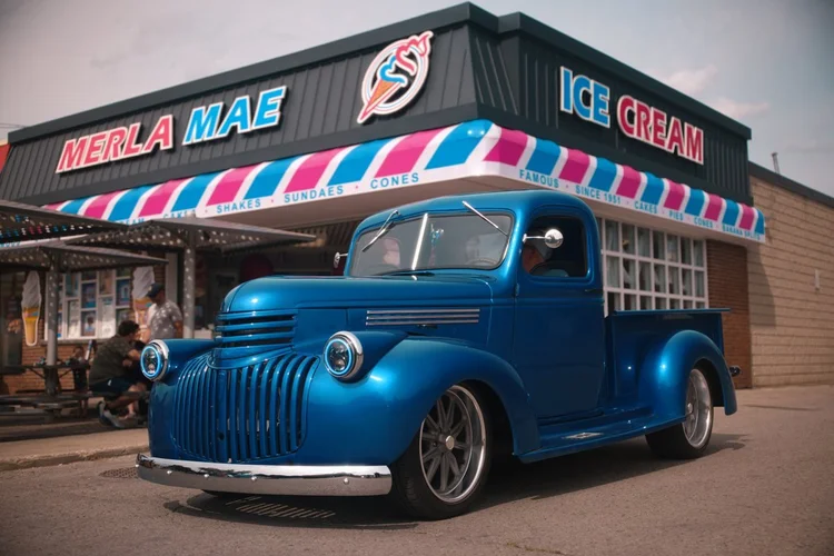 Blue 1946 Chevrolet pickup parked outside Merla-Mae Ice Cream at the Chrome & Cones Car Show