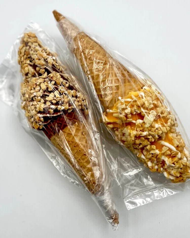 Two individually wrapped ice cream drumsticks, chocolate and butterscotch, from Merla-Mae Ice Cream in London, Ontario