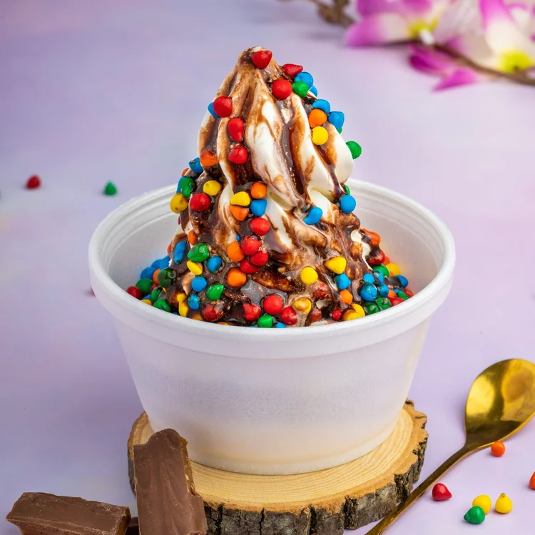 Rainbow Brite sundae with chocolate sauce and rainbow chocolate chips on soft-serve at Merla-Mae Ice Cream in London, Ontario