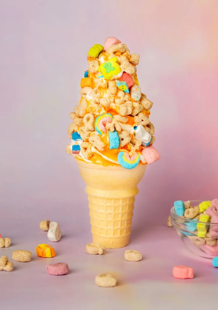 Vanilla soft-serve cone with orange dip rolled in Lucky Charms cereal at Merla-Mae Ice Cream in London, Ontario