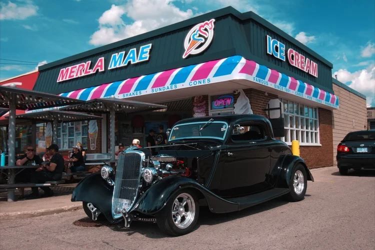 1933 Ford Coupe all-steel hot rod parked outside Merla-Mae Ice Cream at the Chrome & Cones Car Show