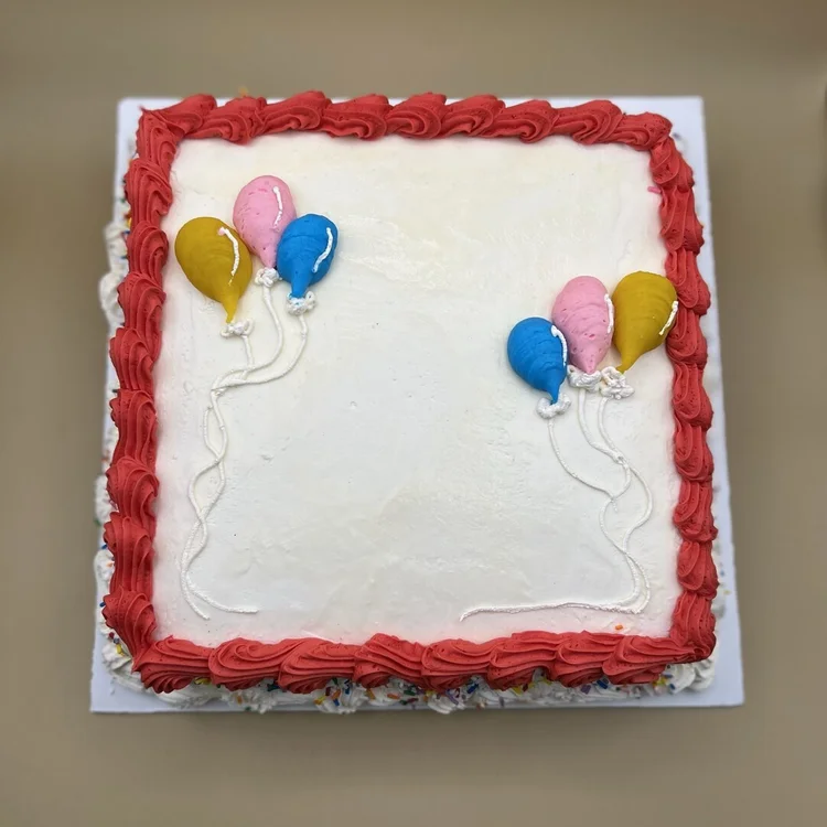 Square ice cream cake with a red piped border and yellow, pink and blue piped balloons at Merla-Mae Ice Cream in London, Ontario